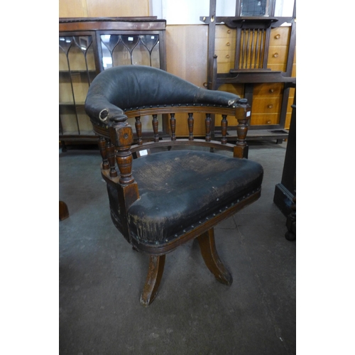 182 - A Victorian oak and upholstered revolving Captain's desk chair