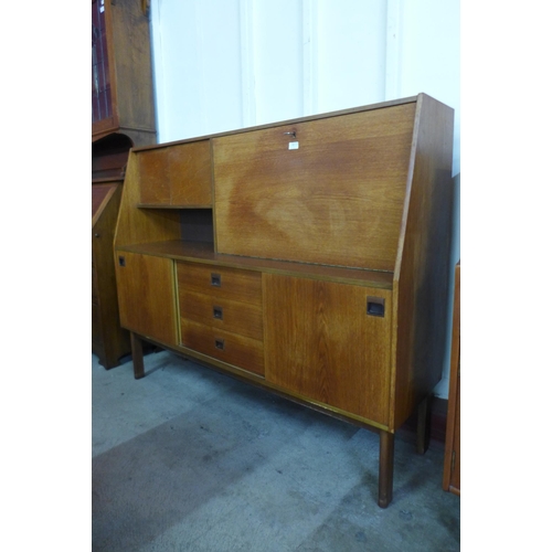 19 - A teak highboard