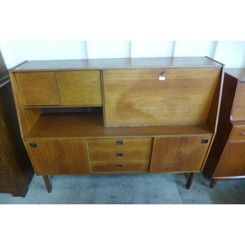 19 - A teak highboard