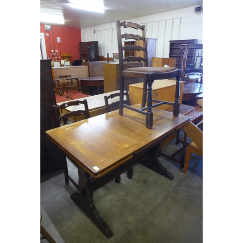 199 - An oak draw-leaf refectory table and three chairs