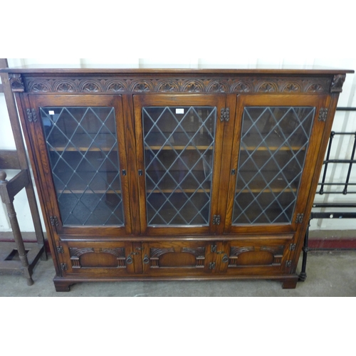 207 - A carved oak three door bookcase