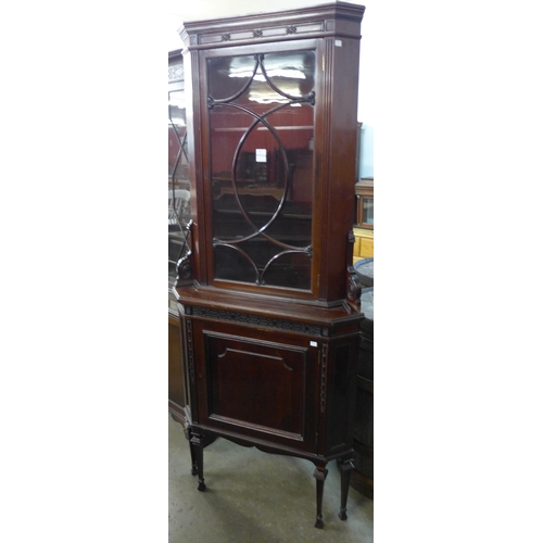 223 - An Edward VII carved mahogany freestanding splay front corner cabinet