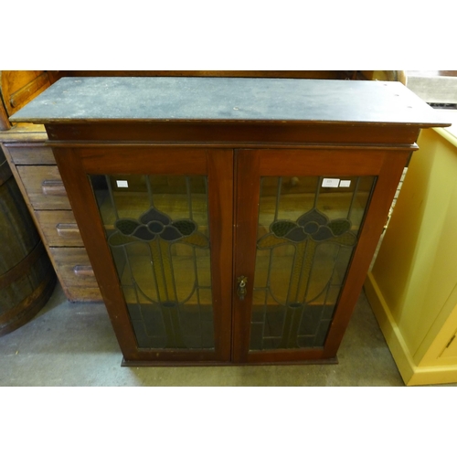 225 - An Art Nouveau mahogany and stained glass bookcase top