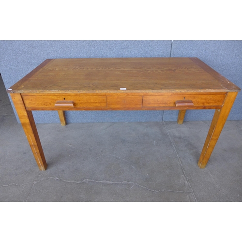 230 - An early 20th Century oak two drawer library table