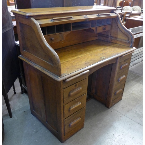 237 - An early 20th Century oak tambour roll top desk