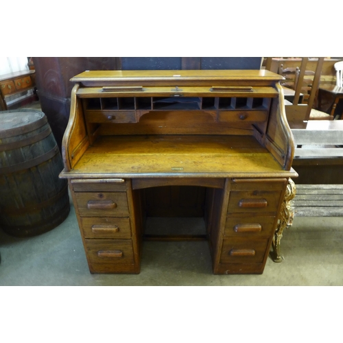 237 - An early 20th Century oak tambour roll top desk