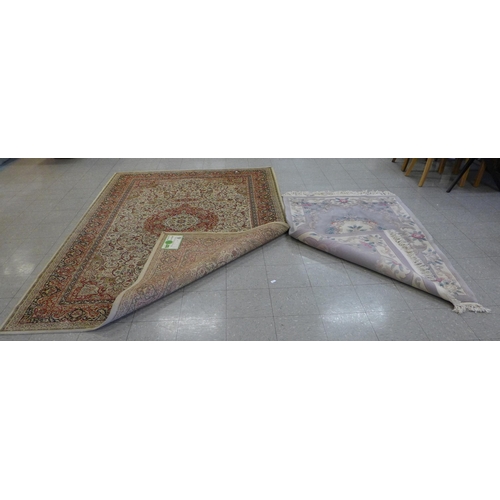 246 - An eastern beige ground rug and a Chinese rug