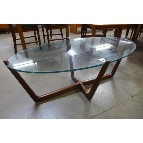 25 - A teak and glass topped oval coffee table