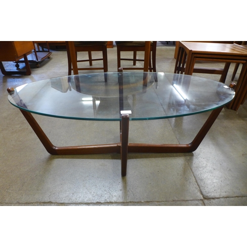 25 - A teak and glass topped oval coffee table