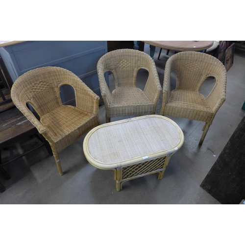 252 - Three wicker armchairs and a coffee table