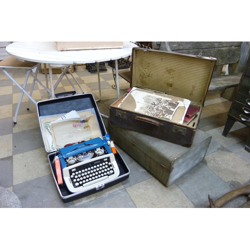 288 - Majesty Publications, a typewriter, two suitcases, one other case, books and brassware, etc.