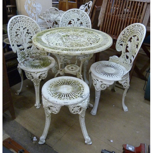 290 - A painted wrought alloy garden table, three chairs and a stool