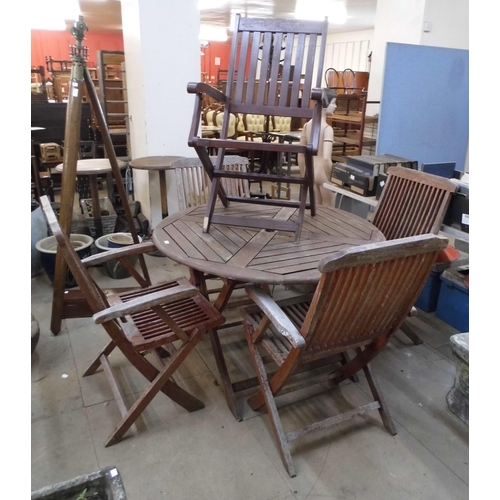 296 - A teak circular garden table and five chairs