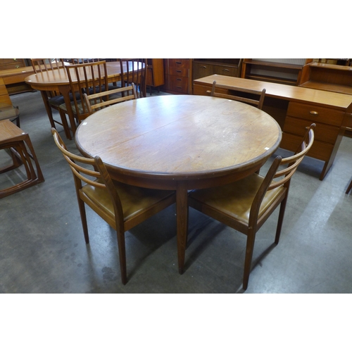 30 - A G-Plan Fresco teak circular extending dining table and four chairs