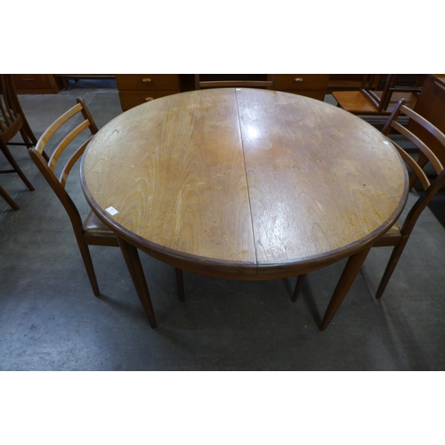 30 - A G-Plan Fresco teak circular extending dining table and four chairs