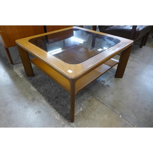 38 - A Nathan teak and glass topped square coffee table