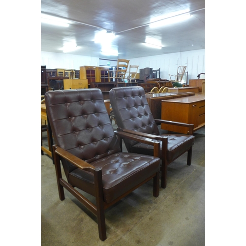 50 - A pair of Scandinavian teak and brown leather armchairs