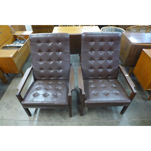 50 - A pair of Scandinavian teak and brown leather armchairs