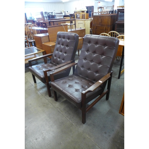 50 - A pair of Scandinavian teak and brown leather armchairs