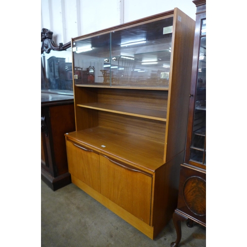 64 - A teak wall unit and a teak chest of drawers