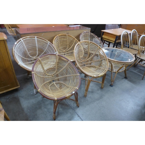 70 - A set of five bamboo chairs and a glass topped coffee table