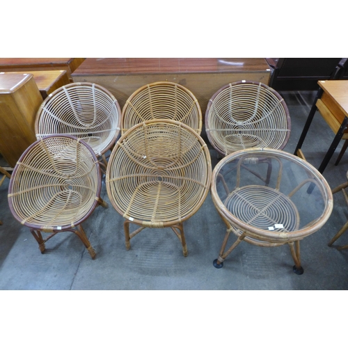 70 - A set of five bamboo chairs and a glass topped coffee table