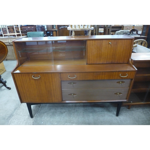 73 - A Nathan tola wood highboard