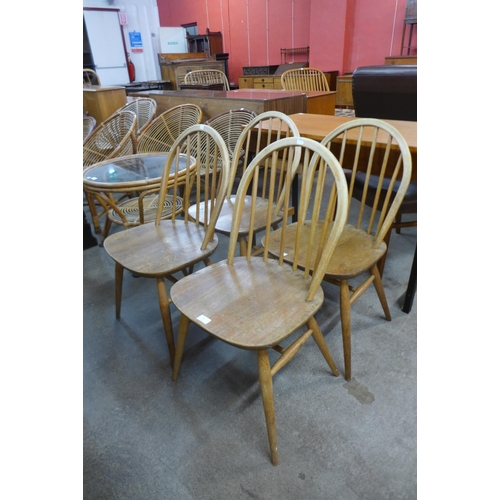 74 - A set of four Ercol Blonde elm and beech Windsor chairs