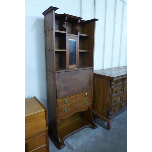 88 - An Arts and Crafts oak secretaire bookcase, manner of E.A. Taylor