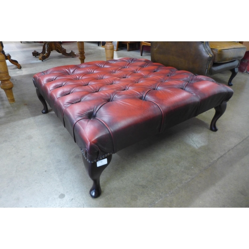 92 - A large Chesterfield oxblood red leather footstool