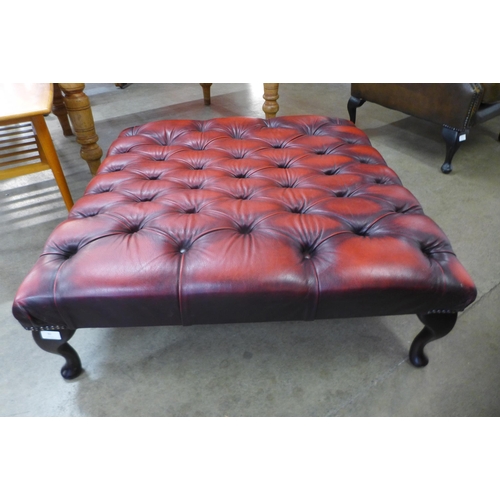 92 - A large Chesterfield oxblood red leather footstool