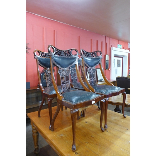 94 - A set of four Art Nouveau mahogany and green leather chairs