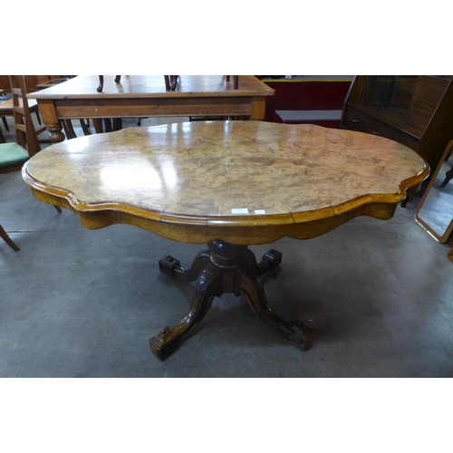 96 - A Victorian figured walnut serpentine tilt top centre table