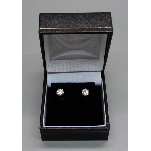 1007 - A pair of hallmarked 18ct gold and diamond stud earrings, total diamond weight 1.06ct