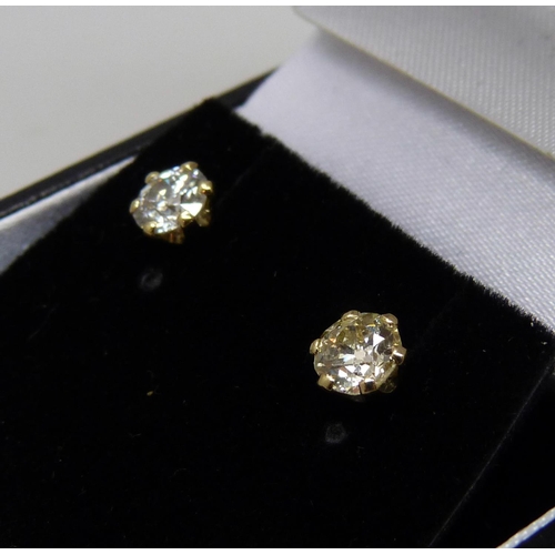 1007 - A pair of hallmarked 18ct gold and diamond stud earrings, total diamond weight 1.06ct