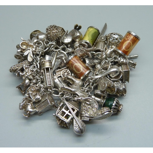 1010 - A heavy silver charm bracelet, 239g