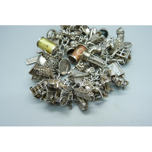 1010 - A heavy silver charm bracelet, 239g