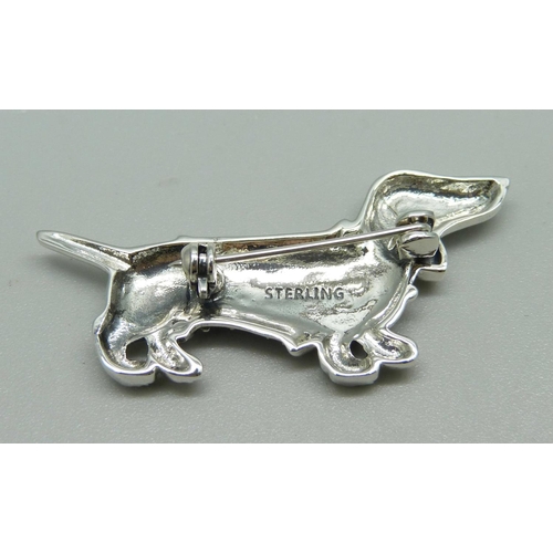 1012 - A silver and ruby Dachschund dog brooch