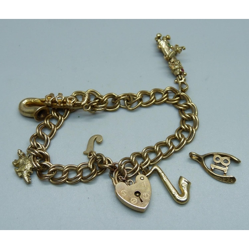 1018 - A 9ct gold charm bracelet, 23.3g