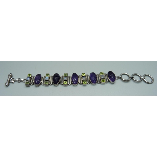 1035 - A silver carved amethyst, peridot and moonstone bracelet