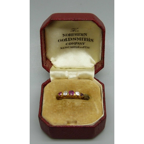 1066 - An 18ct gold, ruby and diamond ring, 2.5g, K, (one stone possibly replaced)