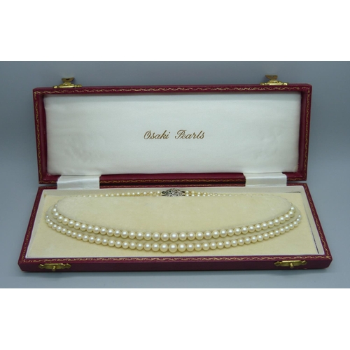 1082 - An Osaki Pearls necklace with silver and marcasite clasp, boxed