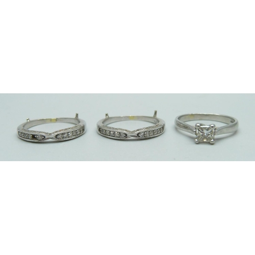 1085 - A platinum triple ring, diamond solitaire approximately 0.60 carat diamond weight, lacking one small... 