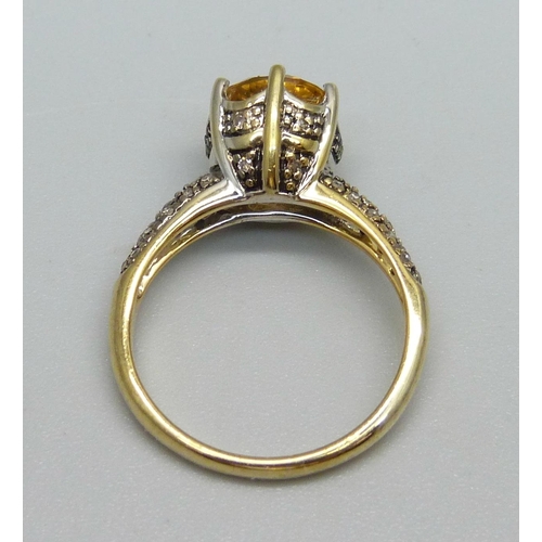 1099 - A silver gilt, citrine and forty champagne diamond ring, N, with certificate