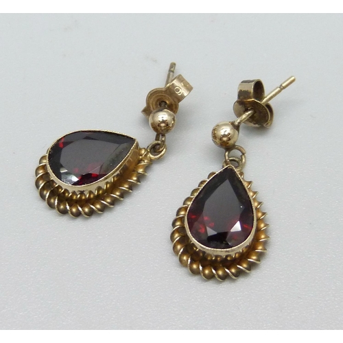 1101 - A pair of 9ct gold and garnet earrings