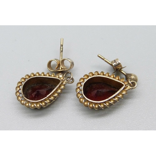 1101 - A pair of 9ct gold and garnet earrings