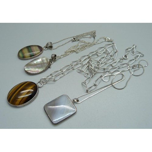 1115 - Four silver and gemstone pendants including tigers eye, fluorite, etc.