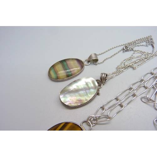 1115 - Four silver and gemstone pendants including tigers eye, fluorite, etc.