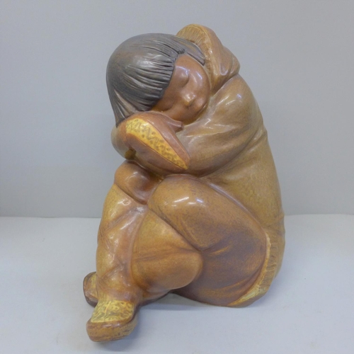 601 - A Lladro figure of a sleeping Inuit boy, 26cm