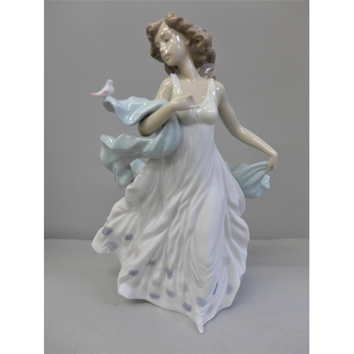 604 - A Lladro figure of a woman with bird, Summer Serenade, 31.5cm